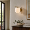 Theo Globe Wall Sconce - Brass Finish with Frosted Milk Glass Shade